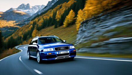 Show an Audi RS 2 Avant cruising down a twisty European mountain road, with the autumn leaves in full display on the trees that line the route. The car should be in motion, with blurred wheels and a sense of speed. The driver should not be visible, but the car should appear to be effortlessly hugging the corners and accelerating through the straights. The overall mood should be nostalgic, with a touch of excitement and adrenaline of 90s Automobiles